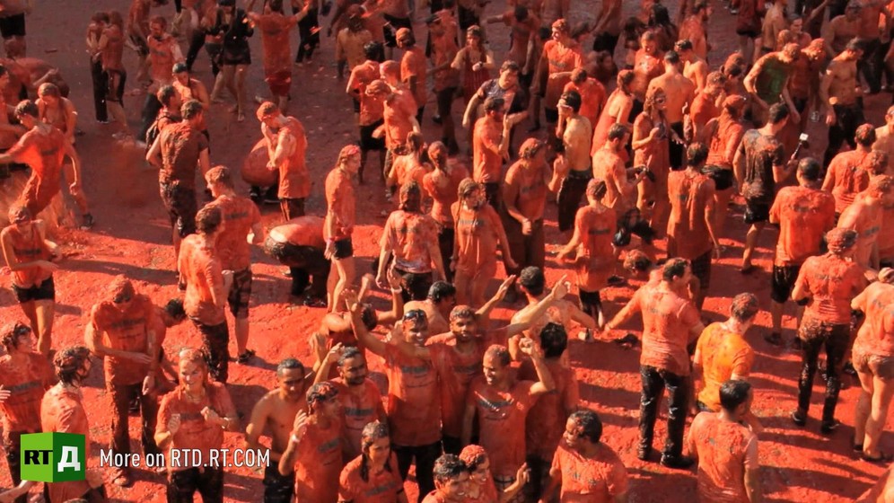 Aerial photograph of a crowd soaked in tomato juice during a tomato fight in the Netherlands. Still taken from RTD documentary Apples of Discord.
