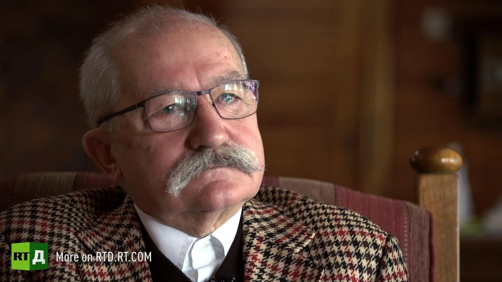 Headshot of elderly Polish farmer with a grey moustache wearing a tweed jacket. Still taken from RTD documentary Apples of Discord.