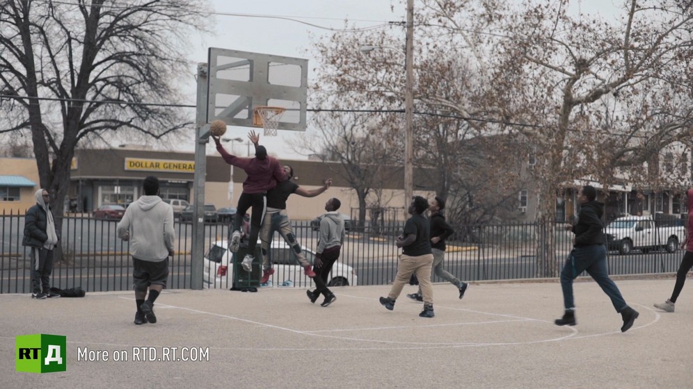 Teenagers play basketball 
