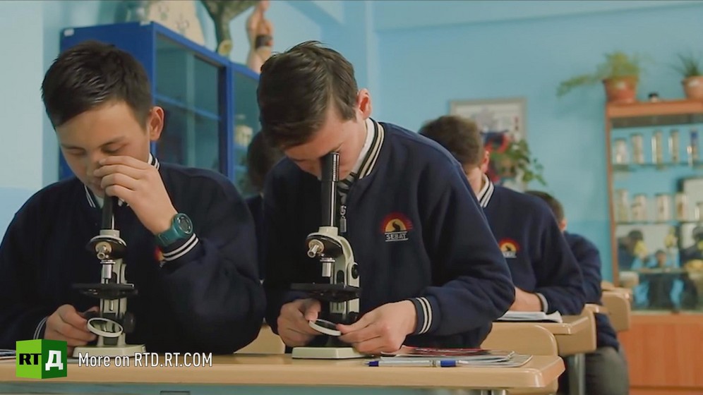In the classroom of a Turkish school in Kyrgyzstan, two boys look through a microscope during science class. Still taken from RTD's documentary series on Fethullah Gulen, The Gulen Mystery, Episode 1: Gulen's Schools.