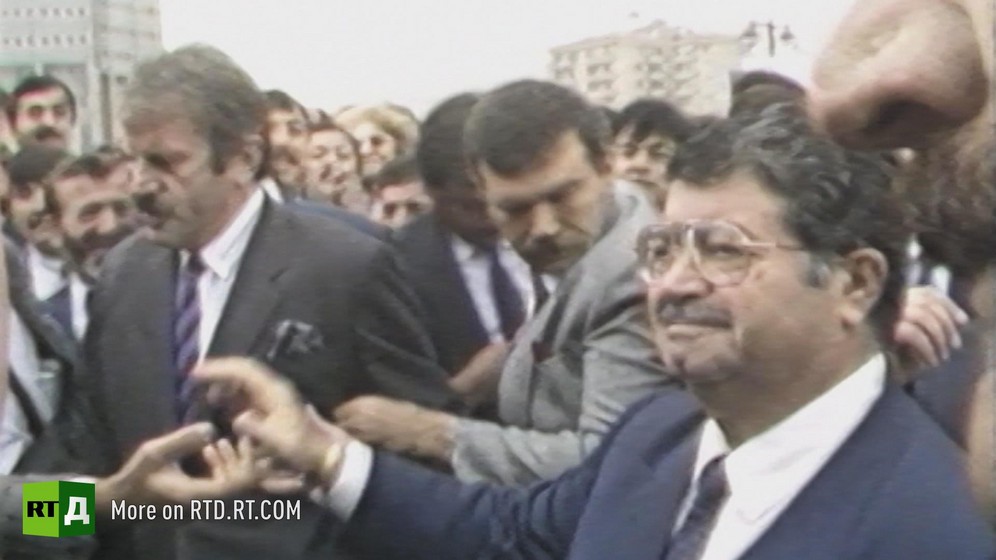 1980s Prime Minister of Turkey Turgut Ozal outside, surrounded by security. Still taken from RTD's documentary series on Fethullah Gulen, The Gulen Mystery, Episode 3: Gulen's Businessmen.