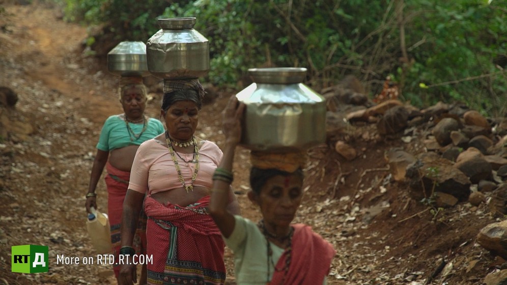 Indian women carry water 
