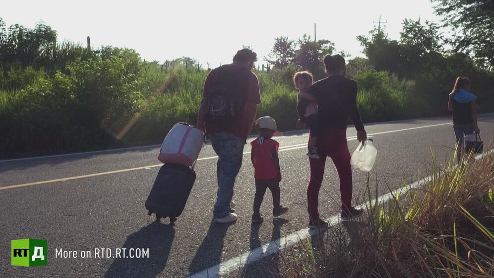 A Central American migrant family walking towards Mexico border
