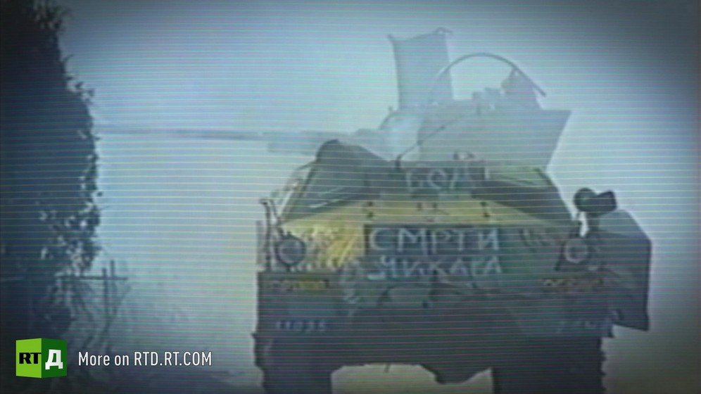 Tank with slogan painted in cyrillic surrounded by smoke / Archive footage from Republika Srpska Radio and Television.