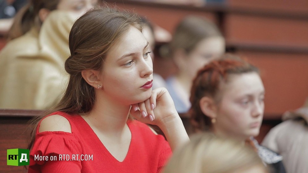 Female student in red top listening to a lecture, Transnistria. Still taken from RTD documentary Seeking Recognition: Transnistria.