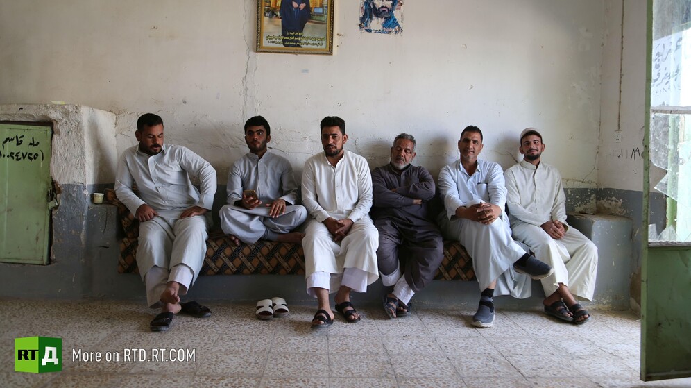 In Wadi Al-Salam cemetery in Najaf, Iraq, a group of gravediggers sit in a grave digger's office. Still taken while filming the RTD documentary Sons of the Graveyard.