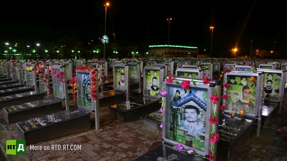 Wadi Al-Salam cemetery in Najaf, Iraq, lit up headstones of militia at nighttime. Still taken while filming the RTD documentary Sons of the Graveyard.