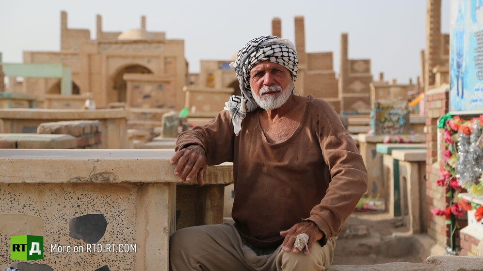 In Wadi Al-Salam cemetery in Najaf, Iraq, a gravedigger sits next to a grave. Still taken while filming the RTD documentary Sons of the Graveyard.