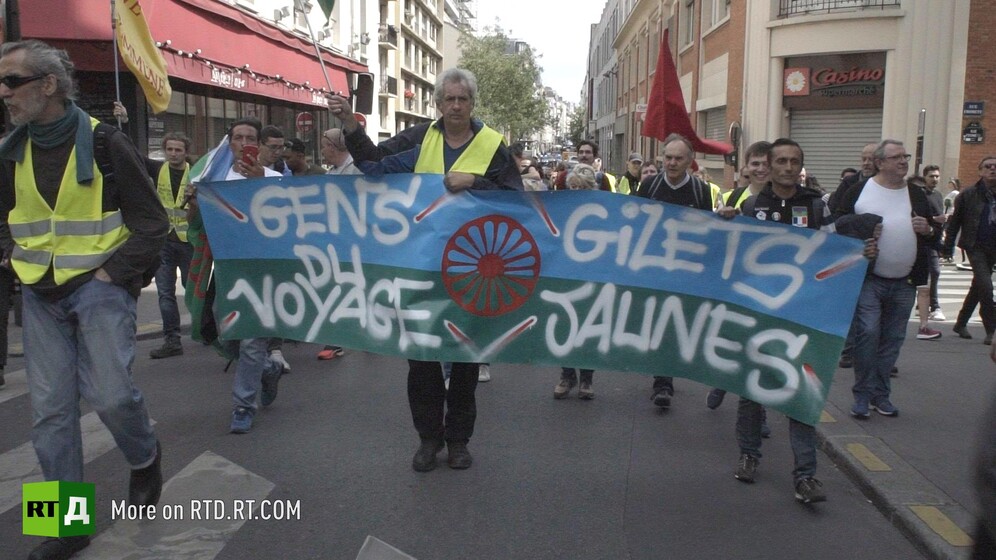 Yellow Vest protestors hold a French Gypsy banner saying "Gens du voyage Gilets Jaunes" in France. Still taken from RTD documentary Tolerance du Voyage.