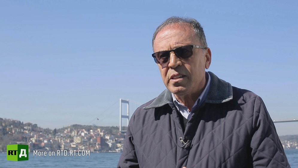 General Ahmet Yavuz wearing sunglasses is standing in front of the Bosphorus in Istanbul, Turkey, on a sunny day with bright blue skies. Still taken from RTD's documentary series on Fethullah Gulen, The Gulen Mystery, Episode 5: Turkey's Coup.