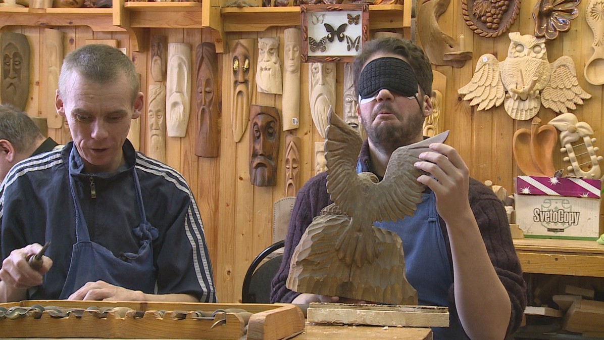 James and Sergey try wood carving at the rehabilitation centre.