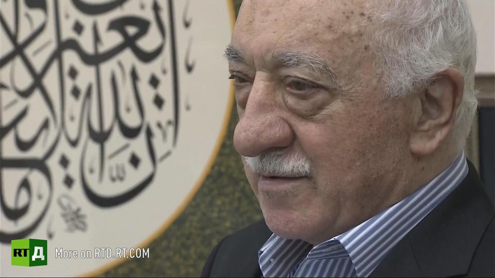 Headshot of Fethullah Gulen next to an inscription in arabic, at his home in Pennsylvania, USA. Still taken from RTD's documentary series The Gulen Mystery.