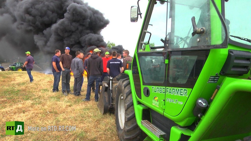 French farmers protesting, tractor and black smoke in background. A still taken from RTD documentary on russian sanctons on EU farm produce, Apples of Discord. 