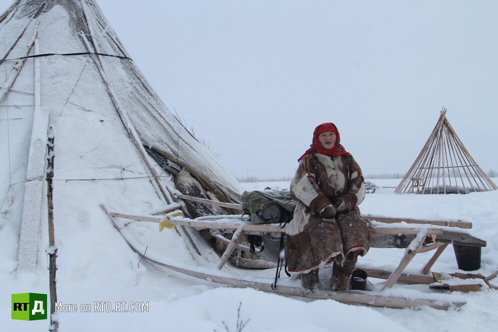 A Nenets woman on a traditional sledge and a chum