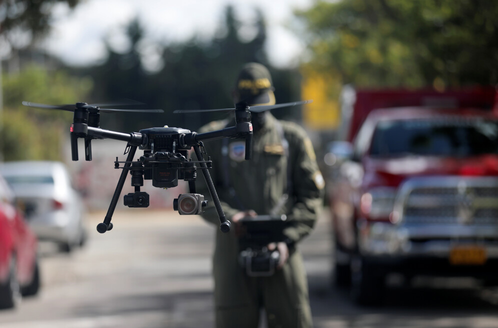 police officer in colombia measures temperature with drones