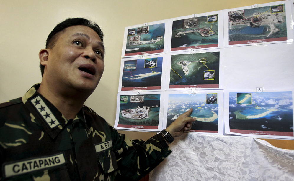 Chief of Staff of the Philippines Armed Gregorio Pio Catapang showing photographs of Chinese constructions on Spratly Islands