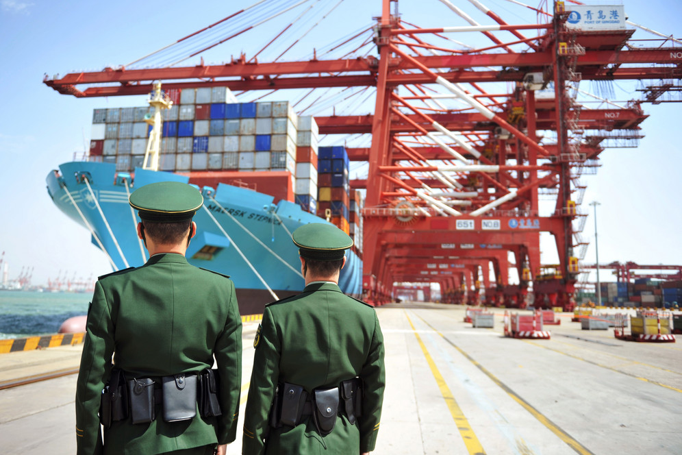 Police in front of cargo ship loading containers in China