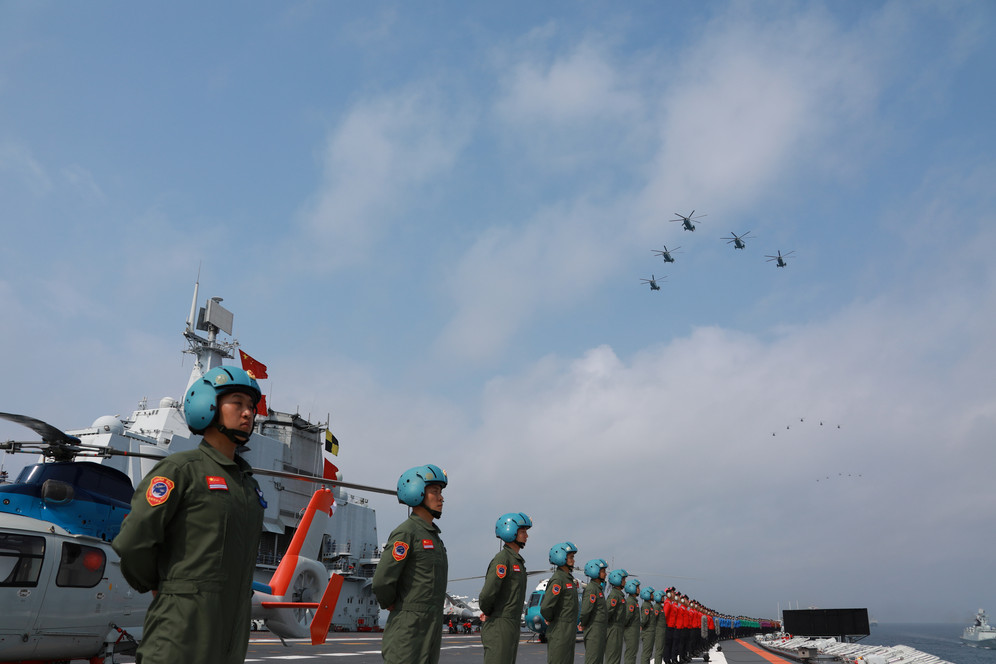 China Navy parading on aircraft carrier in South China Sea