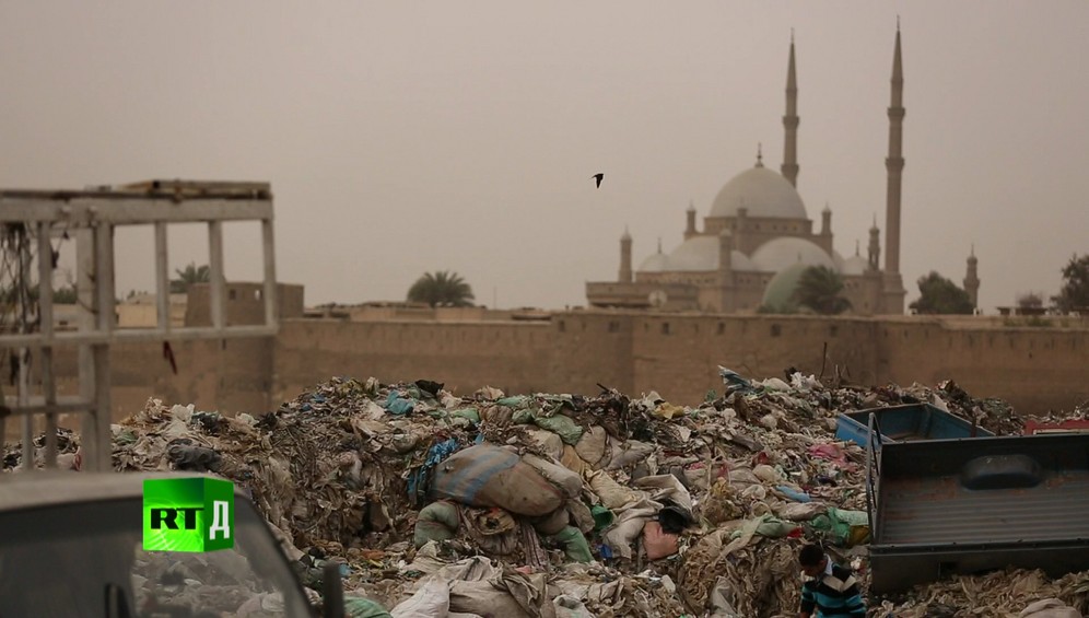 Landfill in the legendary Zabbaleen's Garbage City, with a Cairo mosque in the background, Egypt