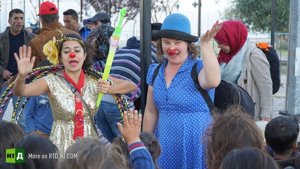 Two women clowns perform for a group of migrant children rescued from the sea in Lesbos, Greece. Still taken from RTD documentary No Laughing Matter.