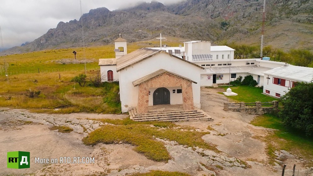 chapel with school on a grassy mountain in rural Argentina, with mist in background. Still taken from RTD documentary Argentinian DNA: A Different Argentina.