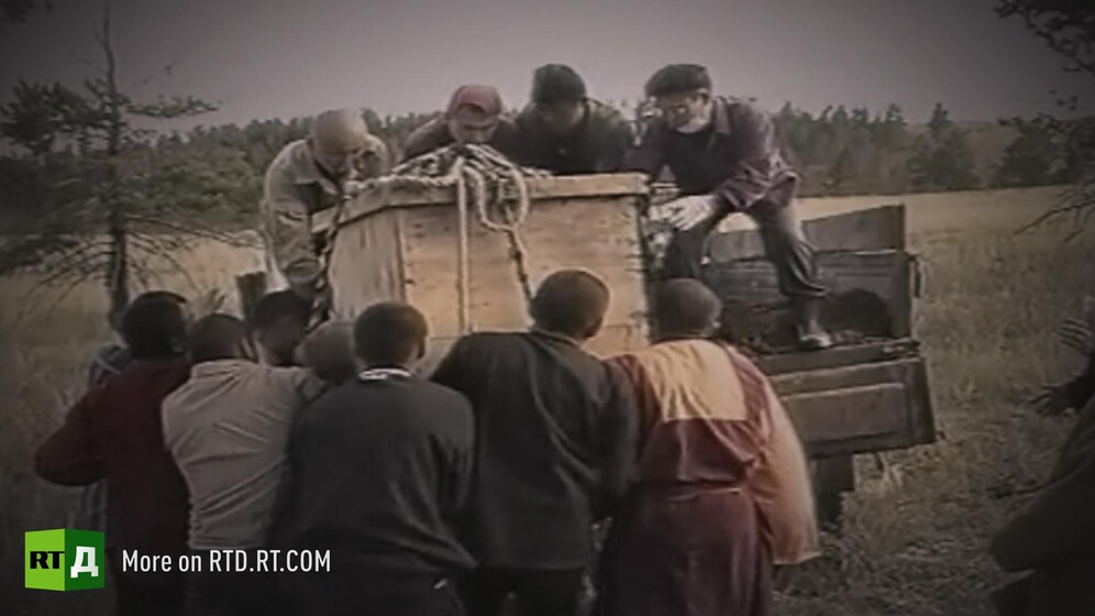 Box containing the remains of Lama Dashi-Dorzho Itigelov carried by a crowd in Buryatia, Russia. Still taken from RTD documentary Searching for a Miracle.