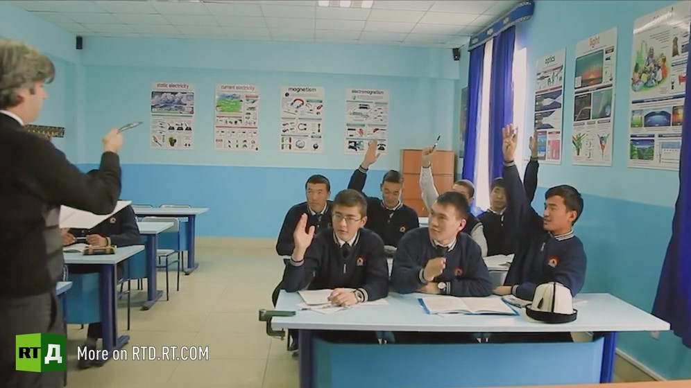 Teenage boys putting their hands up to answer a teacher during class in one of Kyrgyzstan's Turkish schools. Still taken from RTD's documentary series on Fethullah Gulen, The Gulen Mystery, Episode 1: Gulen's Schools.