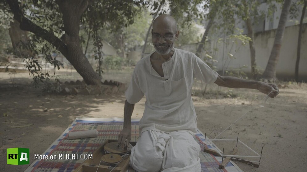 Gandhian using a hand-spinning wheel. Still taken from RTD documentary Gandhi's Footsteps.