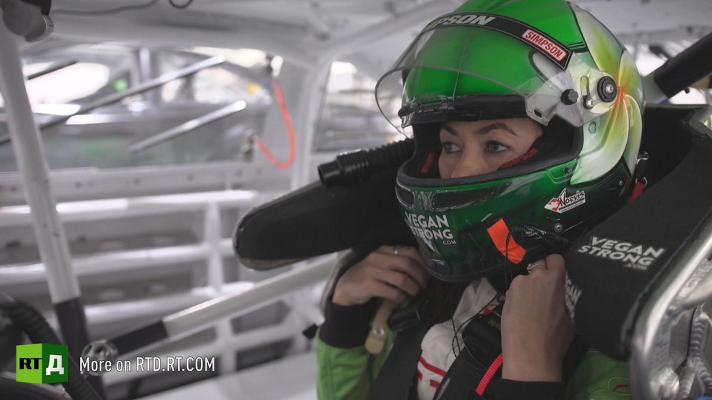 Leilani Münter putting on a helmet in a racing car. Still taken from RTD documentary Kidless.