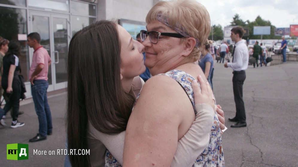 Beslan attack survivor, Irina Gurieva hugs her mother at Belsan airport. Still taken from RTD documentary Living for the Angels.