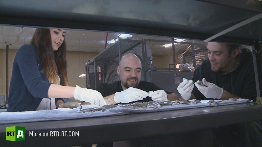 Two men and a woman handle silver coins at the Republic of Texas mint. Still taken from RTD documentary The Republic of Texas.