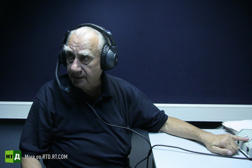 George Watts wearing headphones in a recording studio.