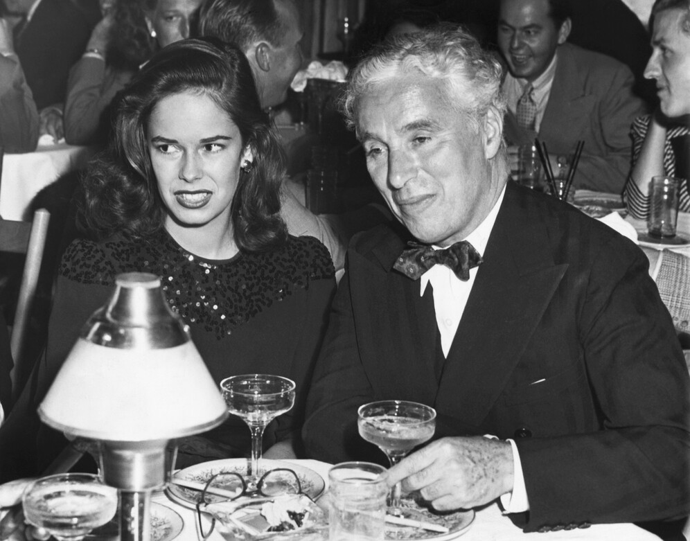 Actor Charlie Chaplin and his new bride, 18-year-old Oona, make their first public appearance at the nightclub Mocambo 