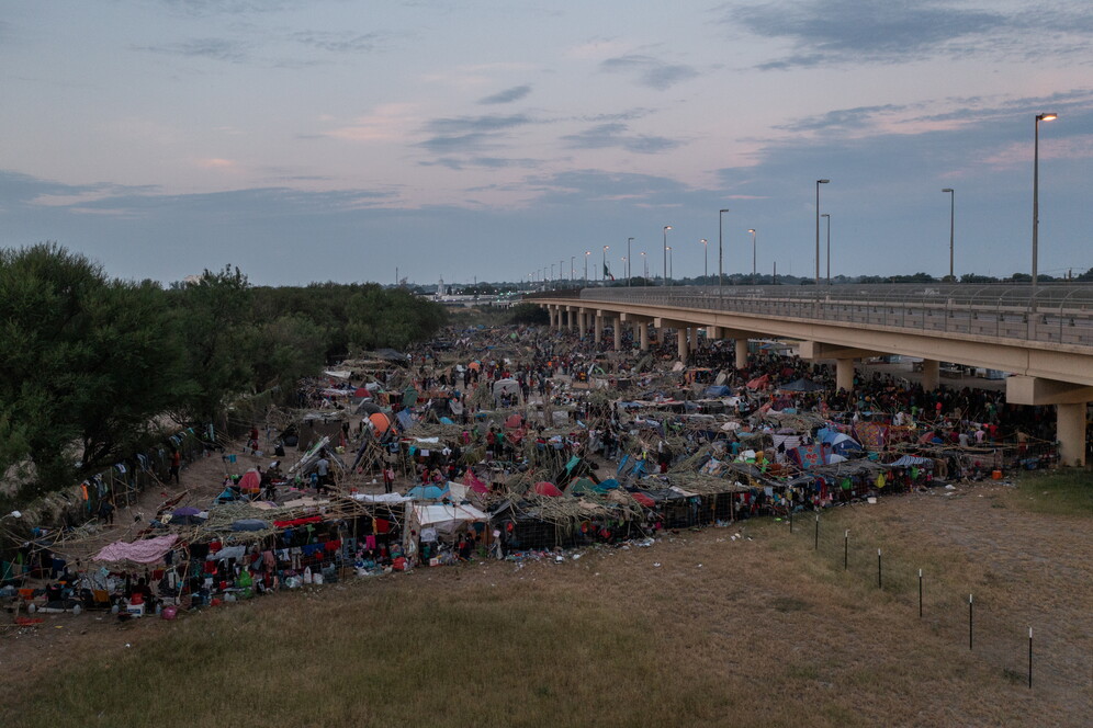 Migrants shelter near the International Bridge in Del Rio US