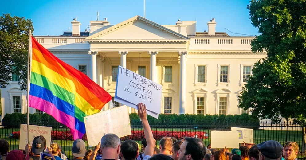 LGBTQ Americans and allies rally outside the White House to protest President Donald Trump's effort to ban trans people from military service. 